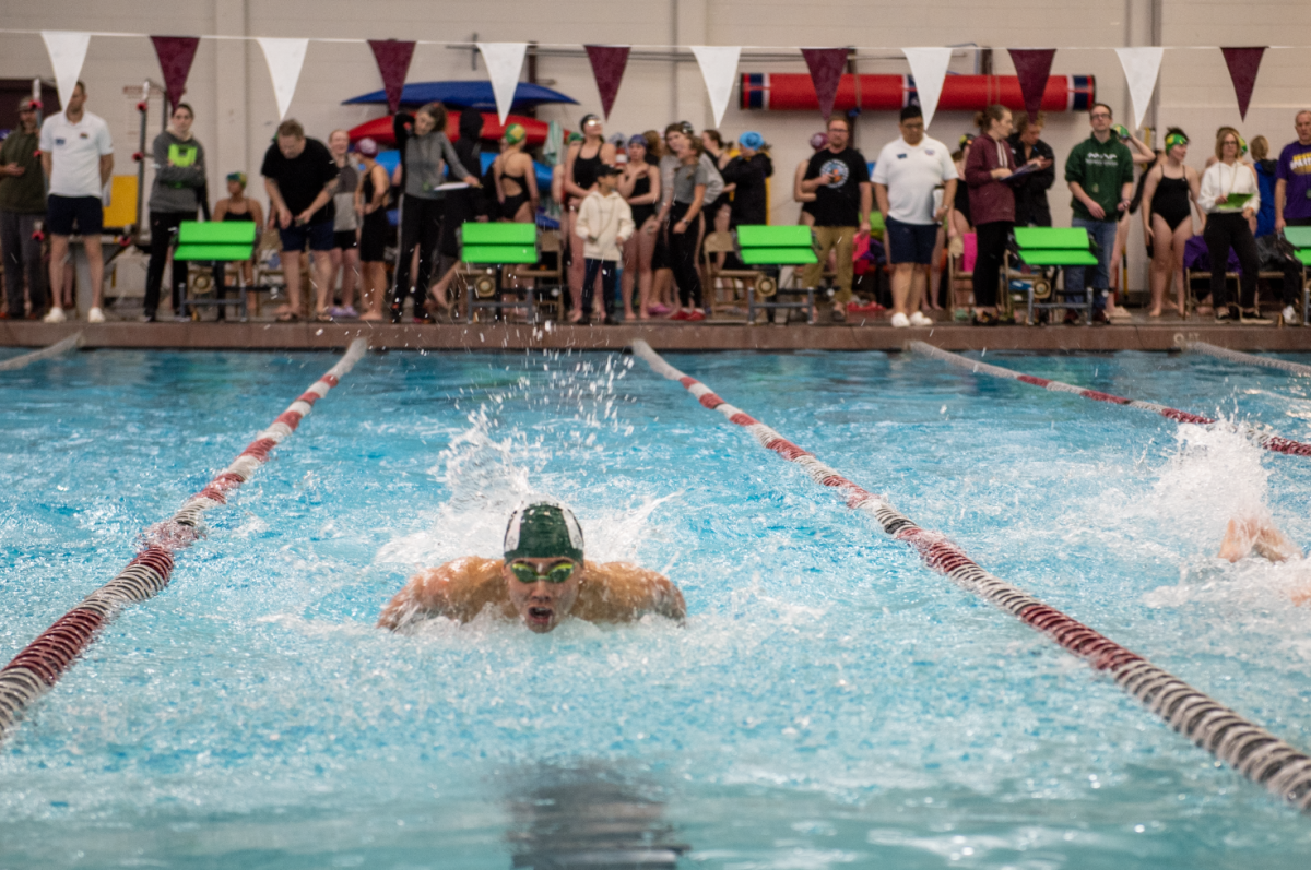 2.1.25 Senior Daniel Apostol swimming the 100 Butterfly at Missoula. 